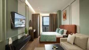 a hotel room with a bed and a couch at ProGarden Luxury Apartments Tirana in Tirana