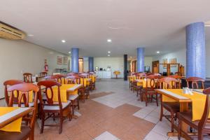 a dining room with wooden tables and chairs at Hotel Express Confort in São Leopoldo