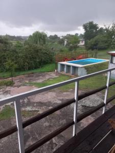 a view from the balcony of a house with a swimming pool at Complejo DYE in Bialet Massé