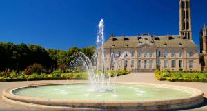 a fountain in front of a large building at Le Gari, Limoges in Limoges
