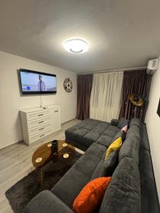 a living room with a couch and a flat screen tv at Apartament David in Neptun