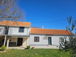 a white house with an orange roof at Holiday Home Nena in Drniš +20 photos