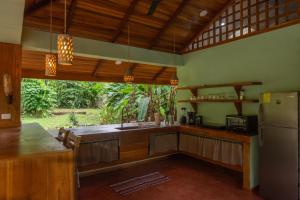 a kitchen with a counter and a refrigerator in it at P2 Tucan in Talamanca
