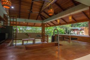 a kitchen with wooden ceilings and a sink in a room at P2 Tucan in Talamanca +7 photos