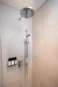 a shower with a shower head in a bathroom at Studio #9 - Self Check-In - Plateau - St-Denis in Montreal