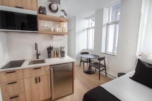 a small kitchen with a sink and a table at Studio #9 - Self Check-In - Plateau - St-Denis in Montreal