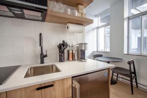 a kitchen with a sink and a counter top at Studio #9 - Self Check-In - Plateau - St-Denis in Montreal +23 photos