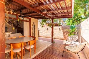 a patio with a table and chairs on a deck at condominio viva barra barra grande casa 136 in Marau