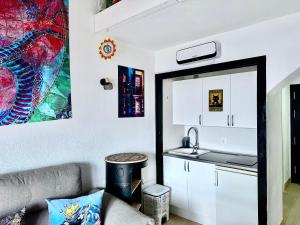a kitchen with a couch and a sink in a room at Estupendo Dúplex en Sierra Nevada in Monachil