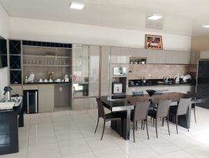 a large kitchen with a dining table and chairs at Casa Blanca in Belém