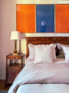 a bedroom with a bed and a table with a lamp at La Giardina Guest House in Chieri