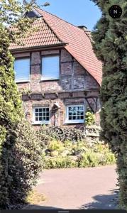 a stone house with a red roof at Ferienwohnung Schmidt in Rosengarten