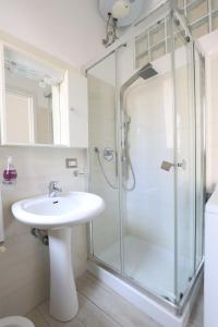 a bathroom with a sink and a glass shower at La Rosa dei Venti in Taormina