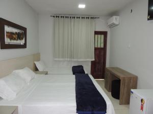 Giường trong phòng chung tại Hotel Continental - Próximo ao Mercado Central, Mercado Novo e a Rodoviária