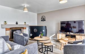 a living room with a couch and chairs and a fireplace at Nice Home In Saint-Samson-De-La-Roq in Saint-Samson-de-la-Roque