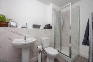 a bathroom with a toilet and a sink and a shower at 1 Bedroom Flat Near Bradford With Free Parking in Saltaire +26 photos