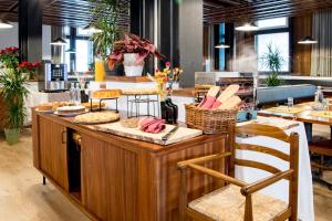 a restaurant with a counter with food on it at Hotel Boite in Borca di Cadore