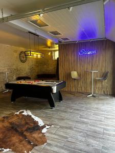 a pool table in a room with a sign at Maison in Chaingy