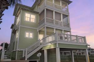 a large green house with a balcony on it at NEW- Gulf Front home 4 bed 4 bath in Indian Pass +51 photos