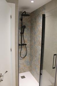 a shower with a shower head in a bathroom at Rincón del Mar in Cala del Moral