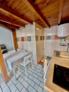 a kitchen with a table and a sink in it at Studio in Hyper Centre Close to All Amenities in Grenoble