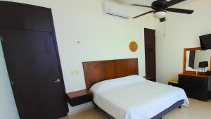 a bedroom with a bed and a ceiling fan at Villa Cos beachfront house in San Benito +36 photos