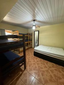 a bedroom with a bed and a ceiling at Chácara Leão Dourado in Pôrto Feliz +6 photos