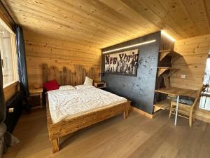 a bedroom with a bed in a wooden room at Chalet Le Bouquetin avec jacuzzi et sauna in Nendaz