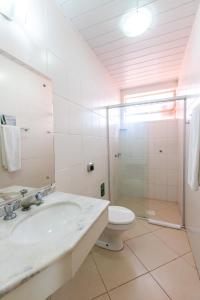 a bathroom with a sink and a toilet at Hotel Express Confort in São Leopoldo