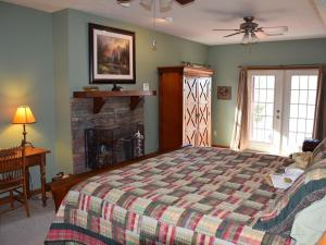 a bedroom with a bed and a fireplace at Long Mountain Lodge Bed & Breakfast in Dahlonega +25 photos