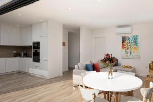 a living room with a white table and a couch at Marco 4 Seasons- Summer in Arco da Calheta