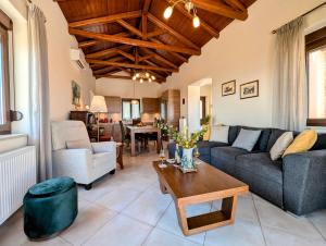 a living room with a couch and a table at Seistron Villa Part of Cretan Retreat in Archanes