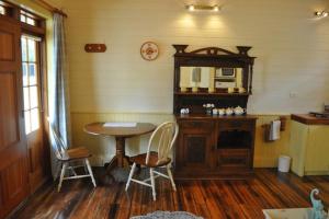 a room with a table and a table and chairs at The Mill House Cottage in Richmond