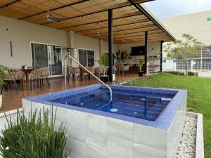 a swimming pool in the backyard of a house at Hit Hoteles Aeropuerto Puebla in Huejotzingo