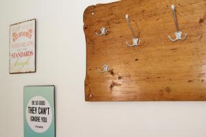 a wooden clock on a wall with a sign at Ferienwohnung 2 ANNA IFF in Würzburg