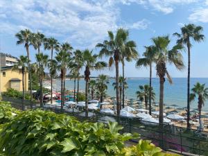 a view of a beach with palm trees and umbrellas at ARCADIA Homes in Alanya