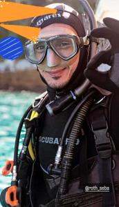 a man in a wetsuit next to a pool at Pousada Kundalini Arraial in Arraial do Cabo