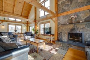 a living room with a fireplace and a stone wall at Secluded Vermont Retreat Outdoor Pool and Deck in Stratton