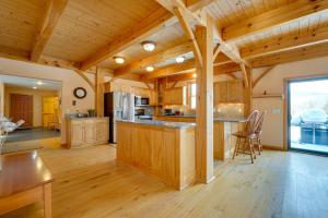 a large kitchen with wooden cabinets and a large window at Secluded Vermont Retreat Outdoor Pool and Deck in Stratton