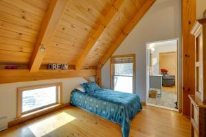a bedroom with a bed in a room with wooden ceilings at Secluded Vermont Retreat Outdoor Pool and Deck in Stratton