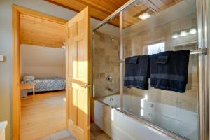 a bathroom with a shower and a bath tub at Secluded Vermont Retreat Outdoor Pool and Deck in Stratton +33 photos