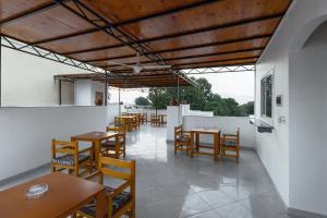 a dining room with wooden tables and chairs at Pharaohs Guest House in Luxor