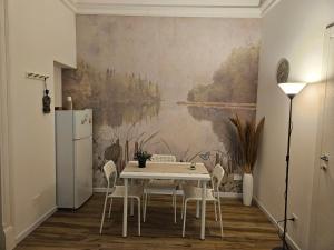 a dining room with a white table and chairs at Sofia's Central Apartment Palermo in Palermo