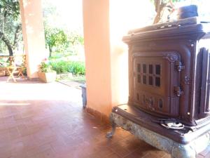an old wood stove sitting on a brick floor at Villa Costanza in San Giovanni