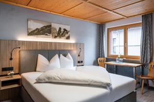 Posteľ alebo postele v izbe v ubytovaní Hotel Garni Madrisa