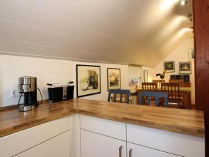a kitchen with a counter top and a dining room at Ferienwohnung im Reetdachhaus, Burhave in Burhave