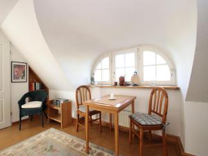 a dining room with a table and two chairs at Ferienwohnung im Reetdachhaus, Burhave in Burhave