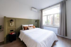a bedroom with a white bed and a window at Cathedral View luxurious Apartment in Antwerp