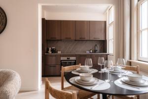 a dining room with a table and chairs and a kitchen at Cathedral View luxurious Apartment in Antwerp
