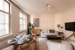 a living room with a table and a couch at Cathedral View luxurious Apartment in Antwerp